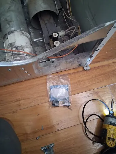 Dryer opened for diagnosis with the exhaust duct and blower exposed