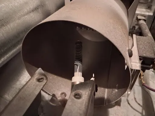 Gas dryer burner tube and igniter inside the dryer cabinet