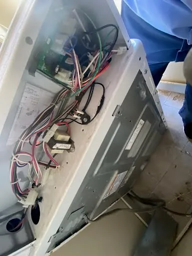 Appliance control panel opened to check wiring and connections during diagnosis